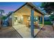 Serene backyard featuring a covered patio, dining area, and lush greenery at 679 Riverband Pl, Henderson, NV 89052