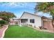 Backyard view highlighting the covered patio and well-maintained artificial lawn at 679 Riverband Pl, Henderson, NV 89052