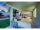 A serene covered patio featuring comfortable seating and a view of the landscaped yard at 679 Riverband Pl, Henderson, NV 89052