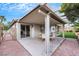 Beautiful backyard with a covered patio, a dining table, and mature landscaping at 679 Riverband Pl, Henderson, NV 89052