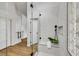 Modern bathroom boasts glass shower with bench, rainfall showerhead and decorative glass block window at 679 Riverband Pl, Henderson, NV 89052