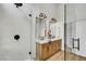 Modern bathroom featuring a glass shower, rainfall showerhead, and double sink vanity with wooden cabinets at 679 Riverband Pl, Henderson, NV 89052