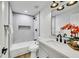 Well-lit bathroom with a shower-tub combo, modern fixtures, and a sleek vanity with a white countertop at 679 Riverband Pl, Henderson, NV 89052
