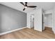 Bedroom featuring wood floors, ceiling fan, and an open door to another room at 679 Riverband Pl, Henderson, NV 89052