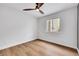Bedroom has wood floors, a ceiling fan, and a sunlit window at 679 Riverband Pl, Henderson, NV 89052
