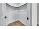 Walk-in closet with wood-style flooring, white walls, and ample storage space at 679 Riverband Pl, Henderson, NV 89052