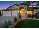 Charming single-story home with a three-car garage, manicured lawn, and welcoming front entrance at 679 Riverband Pl, Henderson, NV 89052