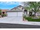 Well-maintained home featuring a three-car garage, stucco exterior, tile roof, and landscaping at 679 Riverband Pl, Henderson, NV 89052