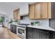 Well-appointed kitchen features a stainless steel range, custom cabinetry, and modern countertops at 679 Riverband Pl, Henderson, NV 89052