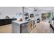 Spacious kitchen with stainless steel appliances, waterfall island, modern lighting, and views to the backyard at 679 Riverband Pl, Henderson, NV 89052
