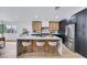 Modern kitchen with stainless steel appliances, a spacious island, and stylish countertops at 679 Riverband Pl, Henderson, NV 89052