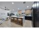 Bright, open kitchen with island seating, modern appliances, contrasting cabinets, and open floorplan at 679 Riverband Pl, Henderson, NV 89052