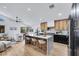 Modern kitchen features an island with seating, and stainless steel appliances at 679 Riverband Pl, Henderson, NV 89052