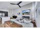 Bright living room featuring modern decor, a fireplace, and an open floor plan to the kitchen at 679 Riverband Pl, Henderson, NV 89052