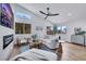 Bright living room featuring modern furnishings, a fireplace, and large windows at 679 Riverband Pl, Henderson, NV 89052