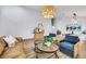 Bright living room featuring modern furnishings, light wood floors, and stylish decor at 679 Riverband Pl, Henderson, NV 89052