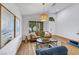 Cozy living room with hardwood floors, comfortable seating, modern decor, and ample natural light at 679 Riverband Pl, Henderson, NV 89052