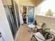 Cozy balcony area with chairs, table, and sliding glass doors leading to a kitchen view at 698 S Racetrack Rd # 322, Henderson, NV 89015