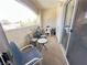 This balcony offers an inviting space to relax with chairs, a table, and a view of the neighborhood at 698 S Racetrack Rd # 322, Henderson, NV 89015