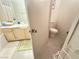 The functional bathroom features a tub/shower, a toilet and vanity with a view into another bathroom at 698 S Racetrack Rd # 322, Henderson, NV 89015