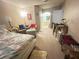 The bedroom includes a bed, seating, desk space and views to the bathroom at 698 S Racetrack Rd # 322, Henderson, NV 89015
