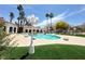 Beautiful community pool area with palm trees, green spaces, and inviting lounge areas at 698 S Racetrack Rd # 322, Henderson, NV 89015