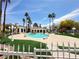 Upscale community pool area with lush landscaping, palm trees, and ornate lighting at 698 S Racetrack Rd # 322, Henderson, NV 89015