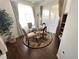 Bright dining area featuring wood floors and a glass table with natural light at 698 S Racetrack Rd # 322, Henderson, NV 89015