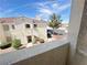 Exterior view of stucco apartment building with beautiful landscaping and parking nearby at 698 S Racetrack Rd # 322, Henderson, NV 89015