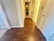 Hallway with hardwood floors and access to various rooms at 698 S Racetrack Rd # 322, Henderson, NV 89015
