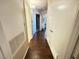 Hallway with wood-look floors and multiple doorways at 698 S Racetrack Rd # 322, Henderson, NV 89015