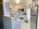 Efficient kitchen with stainless steel refrigerator and white appliances at 698 S Racetrack Rd # 322, Henderson, NV 89015