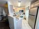 Well-lit kitchen with stainless steel fridge and ample counter space at 698 S Racetrack Rd # 322, Henderson, NV 89015