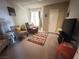 Cozy living room features comfortable seating, a colorful rug, and plenty of natural light at 698 S Racetrack Rd # 322, Henderson, NV 89015