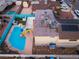 Aerial view of a backyard pool with slide and a house with a grey roof and a small garden at 7018 Berkshire Pl, Las Vegas, NV 89147