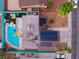 Aerial view of a house with a backyard pool, solar panels, and palm trees on a sunny day at 7018 Berkshire Pl, Las Vegas, NV 89147