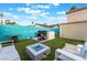 Backyard features a built-in barbeque, patio seating, fire pit and privacy fence at 7018 Berkshire Pl, Las Vegas, NV 89147