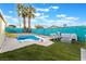 Backyard features a diving board, patio seating, fire pit, and privacy fence at 7018 Berkshire Pl, Las Vegas, NV 89147
