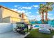 Backyard features a built-in barbeque, patio seating, fire pit, pool and privacy fence at 7018 Berkshire Pl, Las Vegas, NV 89147