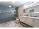 Modern bathroom featuring a walk-in shower, dual vanity sinks and marble floors at 7018 Berkshire Pl, Las Vegas, NV 89147