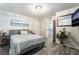 This bedroom has wood floors, a bed, and a beach themed print at 7018 Berkshire Pl, Las Vegas, NV 89147