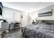 This bedroom includes wood floors, a bed, a window and a tv at 7018 Berkshire Pl, Las Vegas, NV 89147