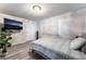 This bedroom features wood floors, a TV, a window and a closet at 7018 Berkshire Pl, Las Vegas, NV 89147