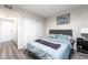 Bedroom features wood floors, bed with blue comforter, and closet at 7018 Berkshire Pl, Las Vegas, NV 89147
