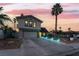 Charming two-story home with a large driveway, well-manicured lawn, and beautiful landscaping at twilight at 7018 Berkshire Pl, Las Vegas, NV 89147