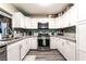 Well-lit kitchen with stone countertops, modern appliances, and white cabinetry, blending style and functionality at 7018 Berkshire Pl, Las Vegas, NV 89147