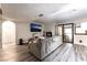 Cozy living room with a fireplace, sliding glass doors and plank flooring, creating a warm and inviting space at 7018 Berkshire Pl, Las Vegas, NV 89147