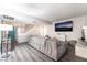 Inviting living room with plank floors, comfortable seating, and easy access to the outdoors, perfect for relaxation at 7018 Berkshire Pl, Las Vegas, NV 89147