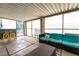 Enclosed patio features a turquoise sofa and chairs, with a neutral coffee table at 7018 Berkshire Pl, Las Vegas, NV 89147