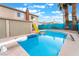 Backyard pool features a diving board, in-pool floats, and privacy fence at 7018 Berkshire Pl, Las Vegas, NV 89147